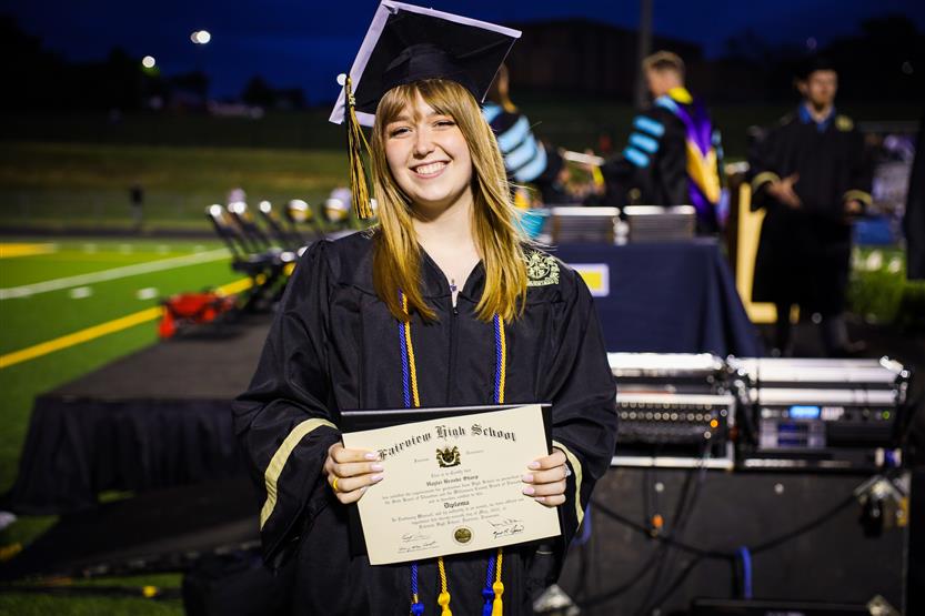 Students graduate on a football field